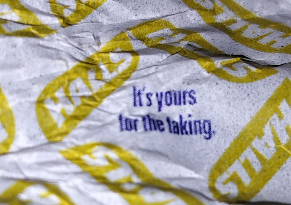 Halls cough drop wrapper has several "motivational" messages. One reads "it's yours for the taking."