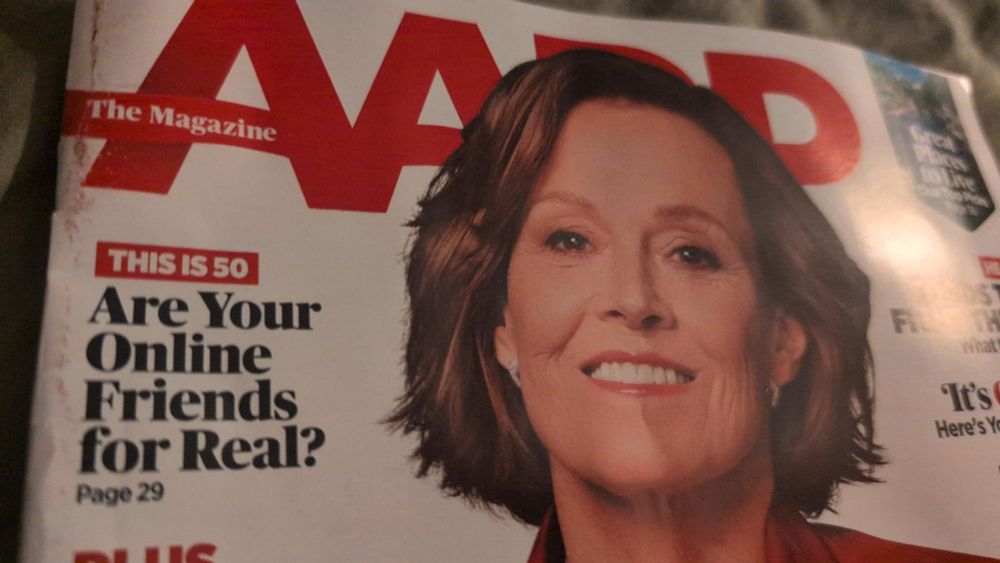 Top part of the cover of the latest issue of AARP The Magazine, featuring a smiling Sigourney Weaver, and the headline for the issue's "This is 50" column, "Are Your Online Friends for Real?"