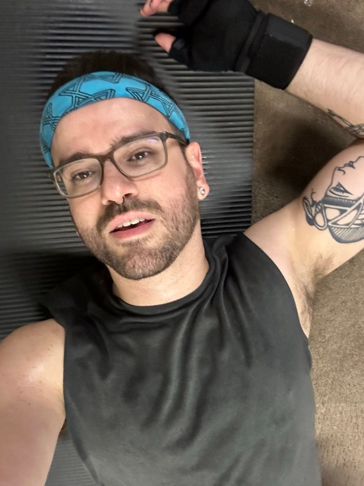 Selfie of me sweaty in workout clothes on my mat