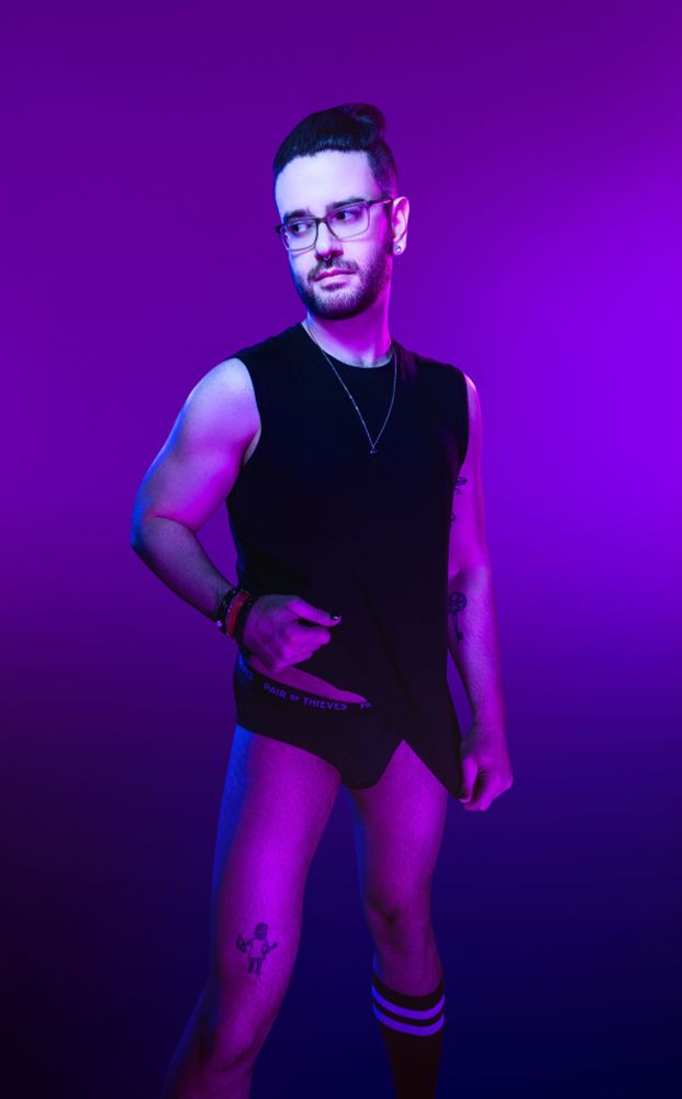 Me being a slut in my underwear and a sleeveless shirt with knee high socks in front of a purple background 