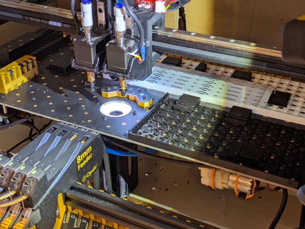 Overview shot of the Opulo pick and place machine loaded with the led panel