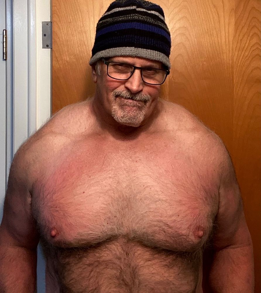 Bare chested selfie with hat.