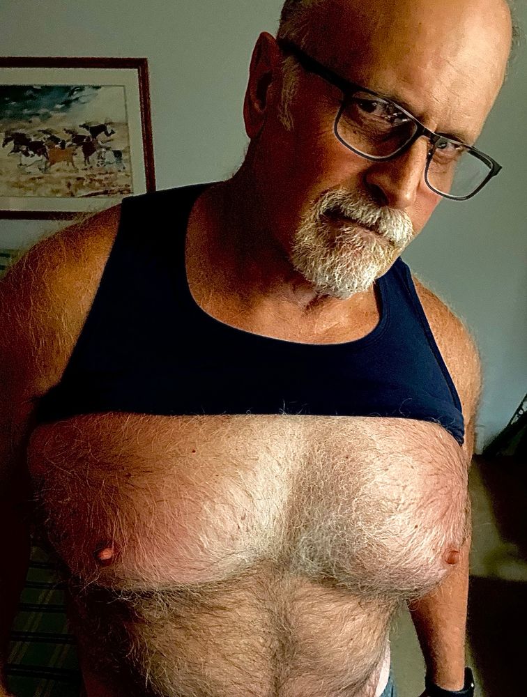 Selfie with tank top pulled up above furry pecs