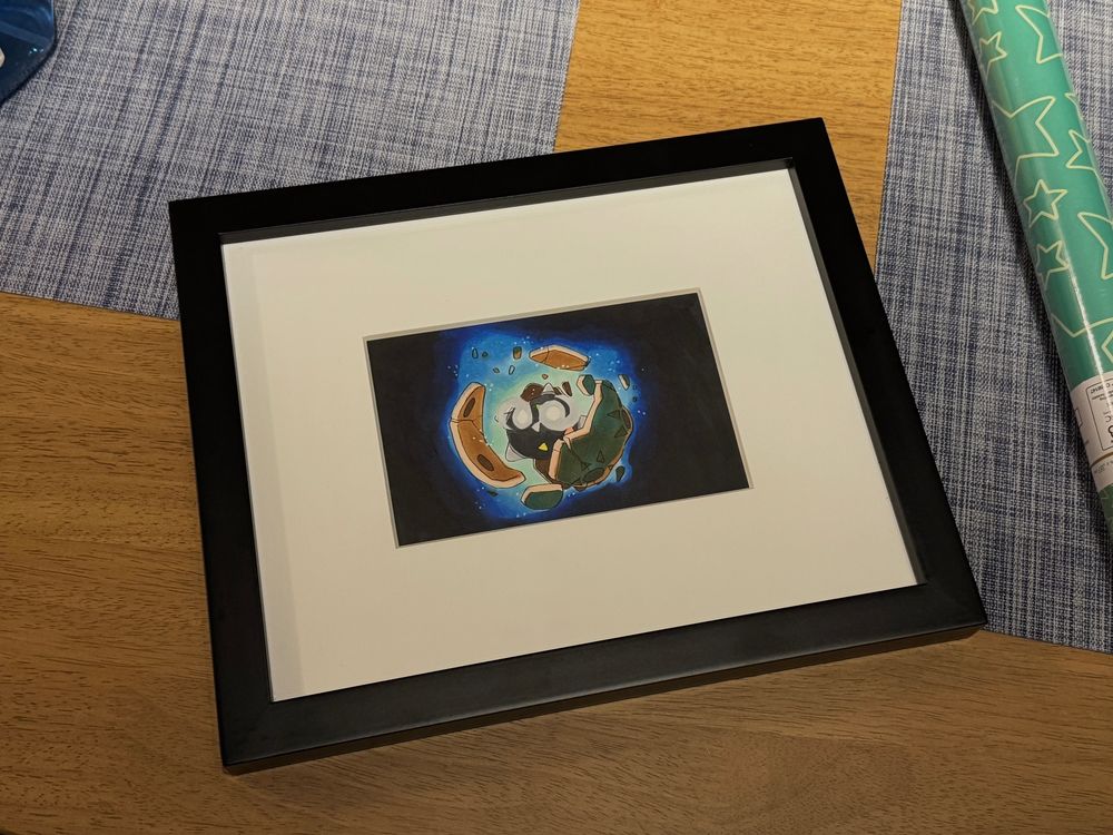 a framed painting of a minior (shiny) bursting out of its shell!