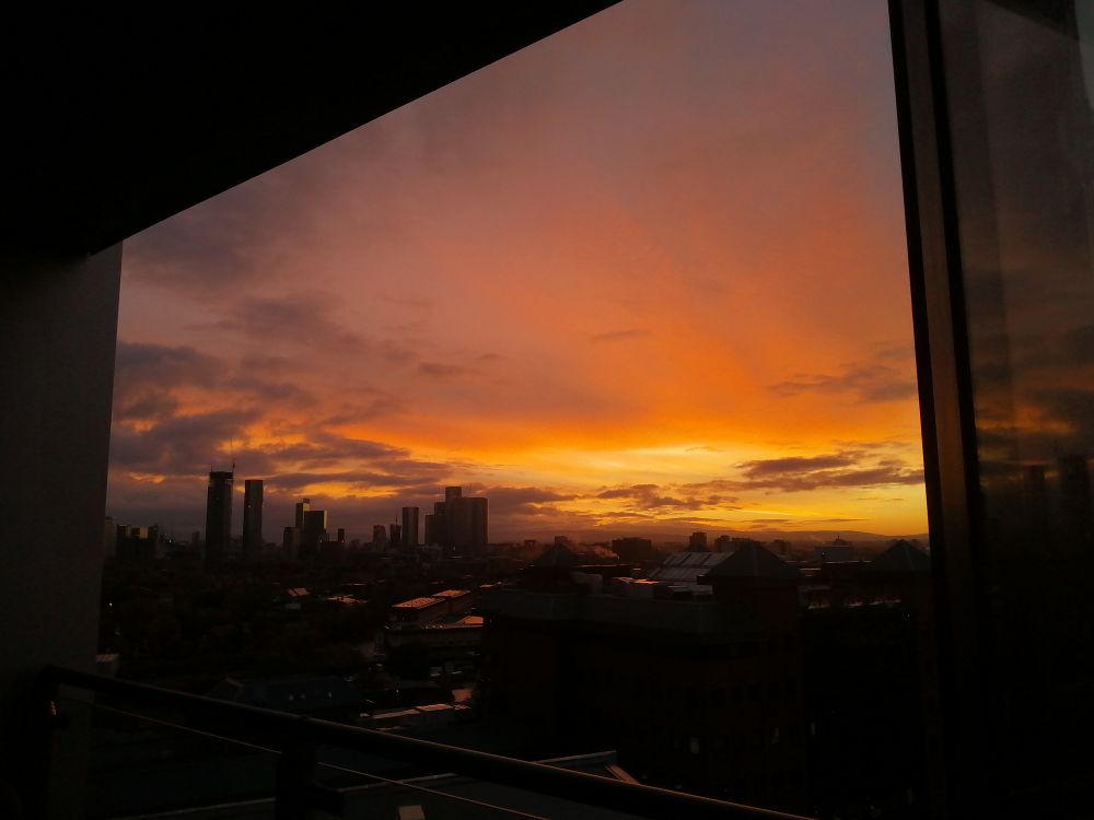 Silhouette of Manchester's skyscrapers in an orange sky