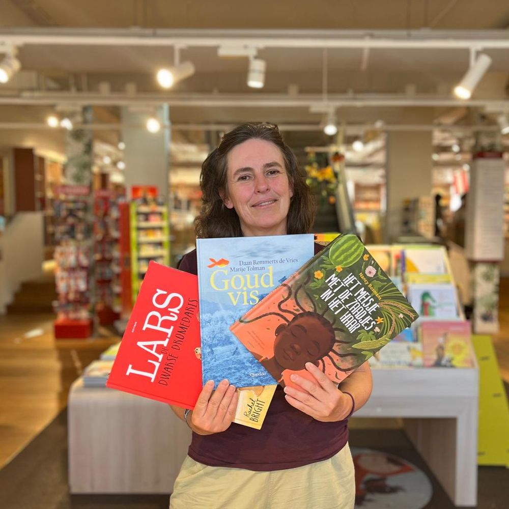 Scheltema-boekverkoper Margaret met favoriete prentenboeken Lars, Goudvis en Het meisje met de zaadjes in het haar