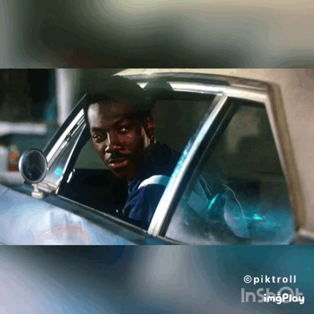 a man is sitting in a car with a watermark of pixtroll