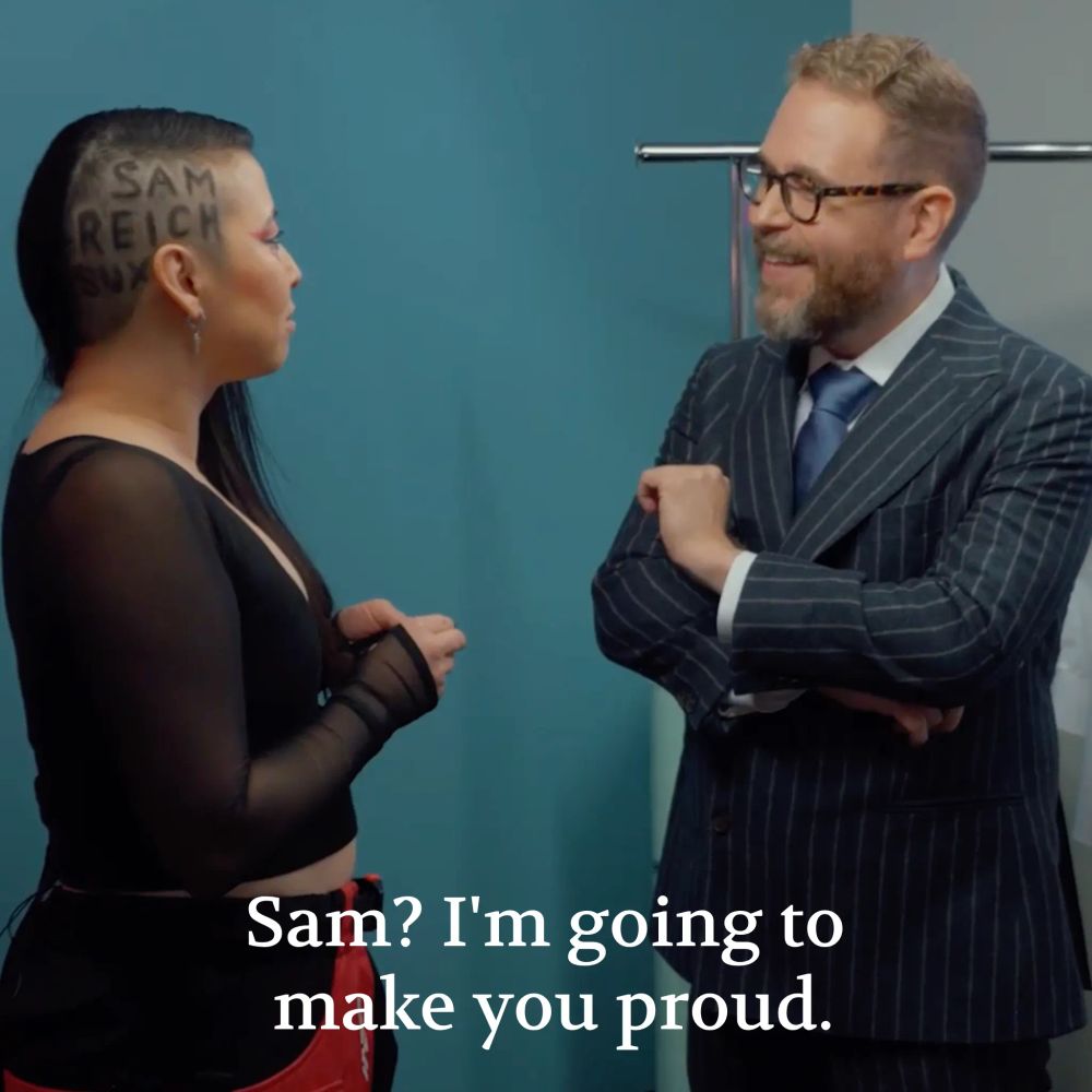 A screenshot of Erika Ishii telling "I'm going to make you proud" while also having the words "Sam Reich Sux" shaved into the side of her head.