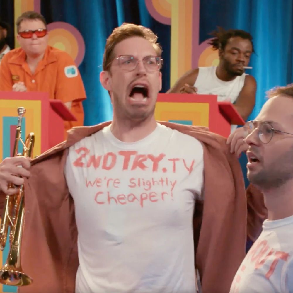 Keith and Zach from Try Guys interrupt an episode of Game Changer with shirts that read "2ndTry.TV - We're slightly cheaper!"