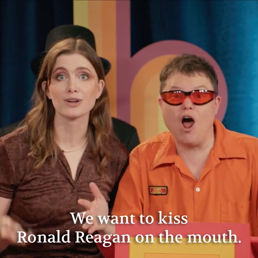 Vic Michaelis and Ally Beardsley looking into camera and saying "We want to kiss Ronald Reagan on the mouth".