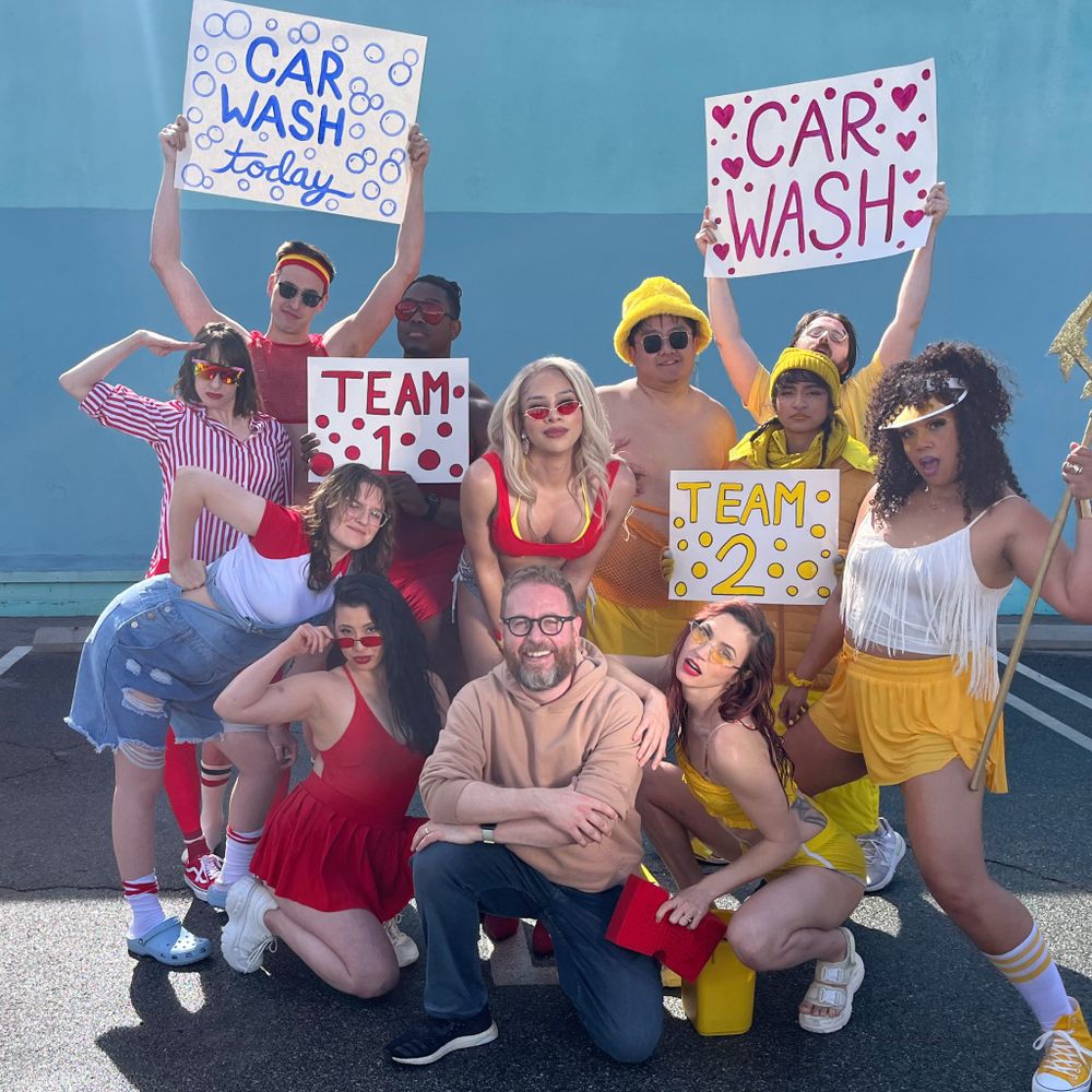 A photo of Sam Reich with Teams 1&2 from Persephone's sexy car wash.