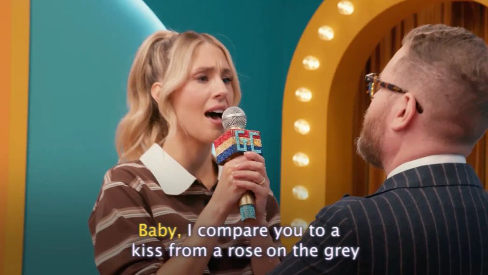 Lisa Gilroy sings Seal's 'Kiss from a Rose' while sharing uninterrupted eye contact with Sam Reich.