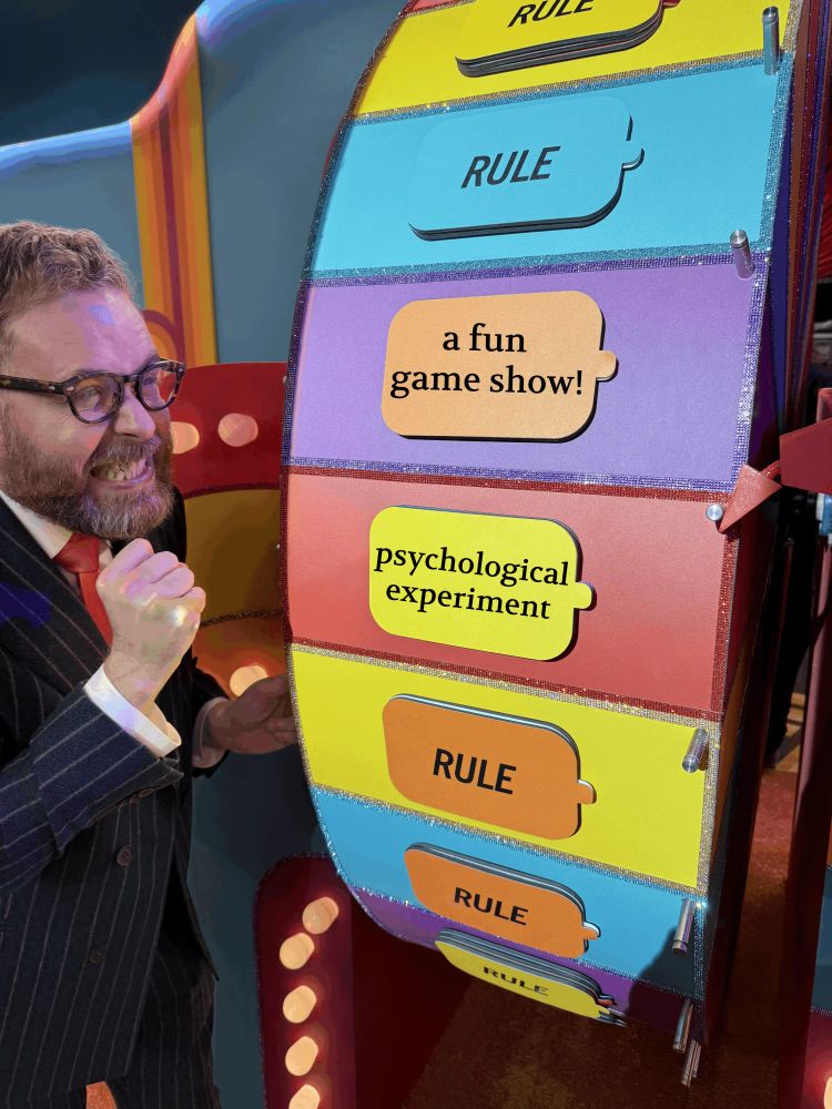 Sam Reich watching the prize wheel with bated breath as the arrow is right on the edge of pointing to "a fun game show", but instead is still technically pointed at "a psychological experiment".