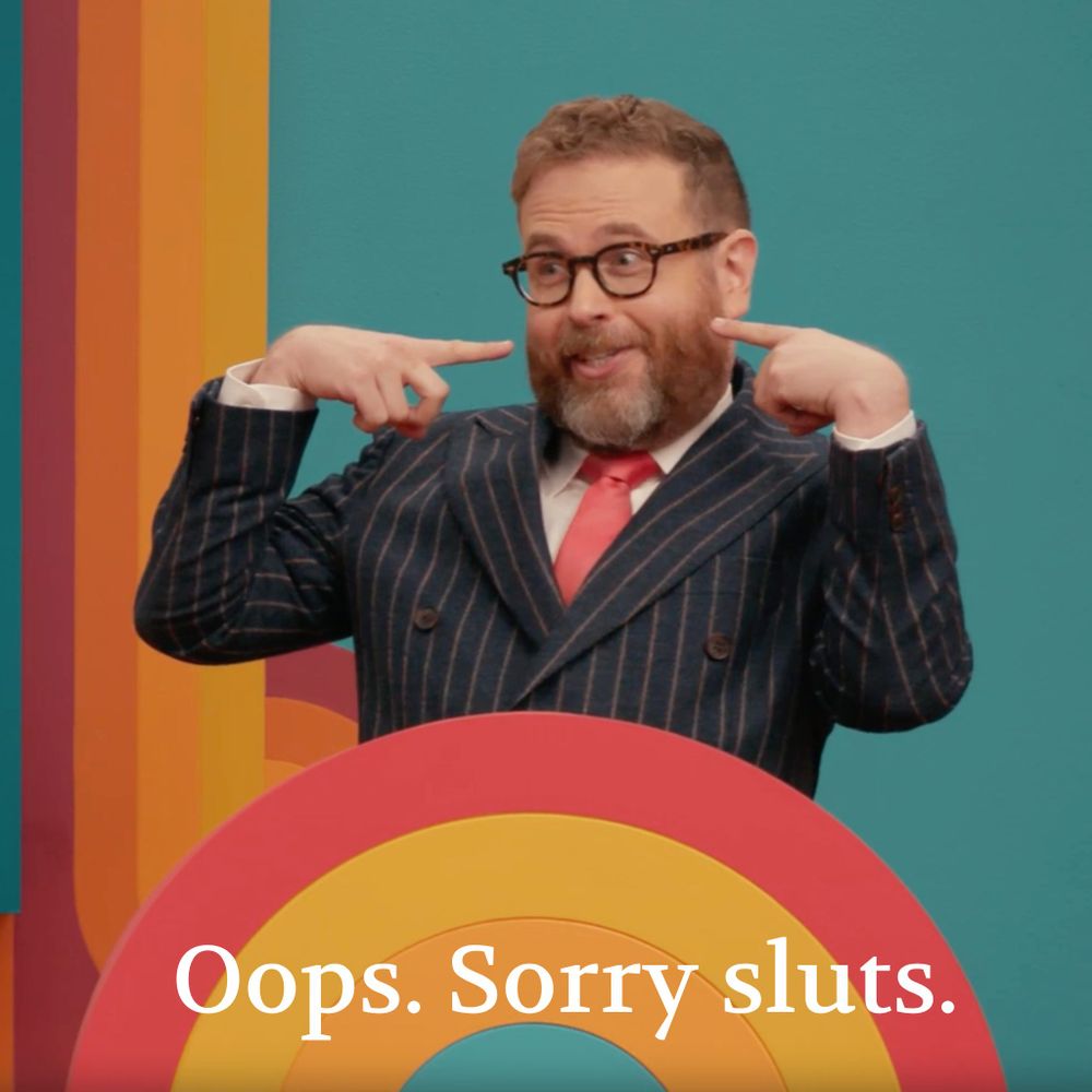 A screenshot of Sam smiling coyly and saying "Oops. Sorry sluts."
