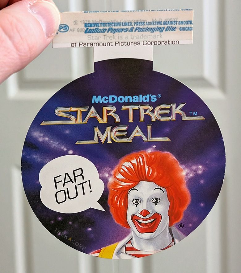 A paper circle sign for McDonald's 1979 "Star Trek Meal," with Ronald McDonald saying "Far Out!"