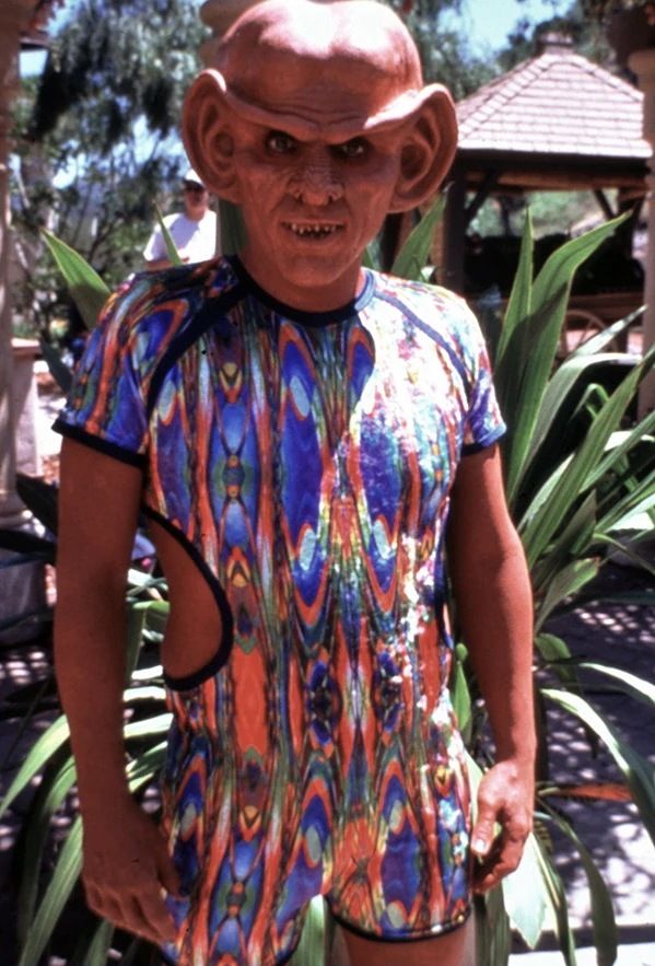 Quark from Star Trek DS9, wearing a colorful swimsuit on the Ba'ku planet.
