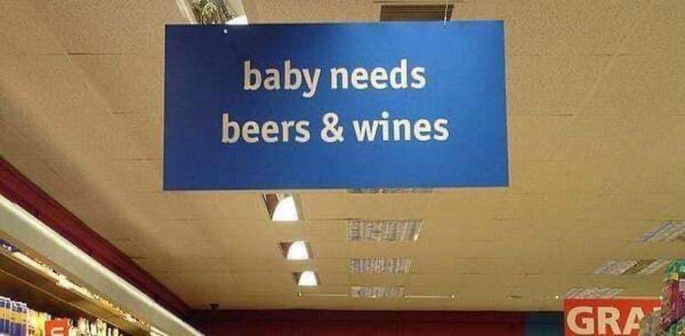 A blue supermarket sign 

BABY NEEDS
BEERS & WINES