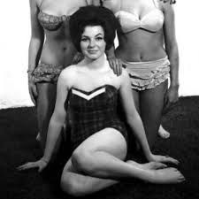 Black and white photo of Delia Smith posing in a vintage swimsuit