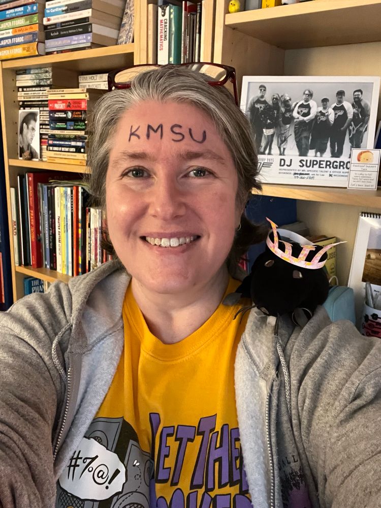 Elizabeth & Zeke Rat pose for a selfie on TMBP TMBG Day. E has KMSU written on her forehead. Zeke is wearing his THEY crown. 