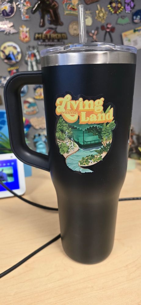 Cup with a Living with the Land sticker 
