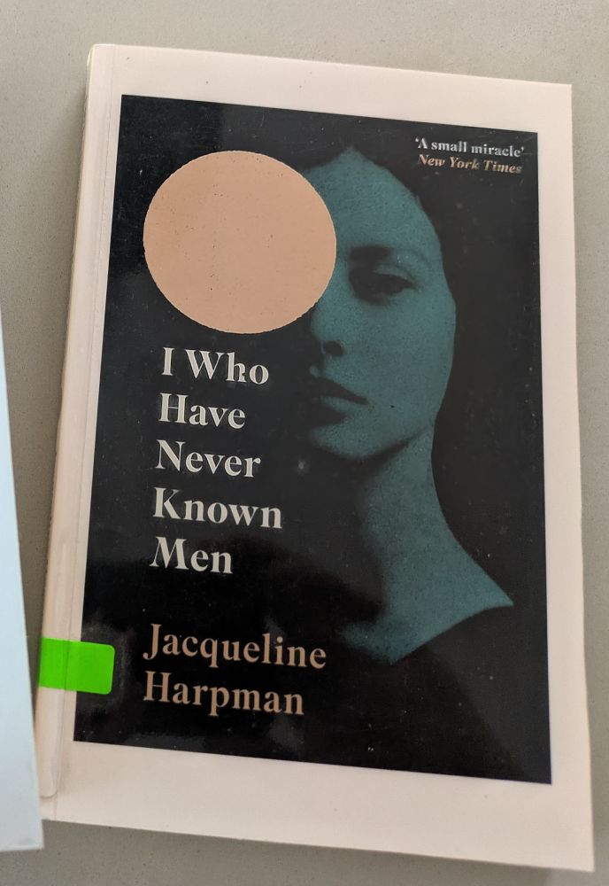 Book cover of I who have never known men with woman's face in shadows and a large circle partly obscuring her