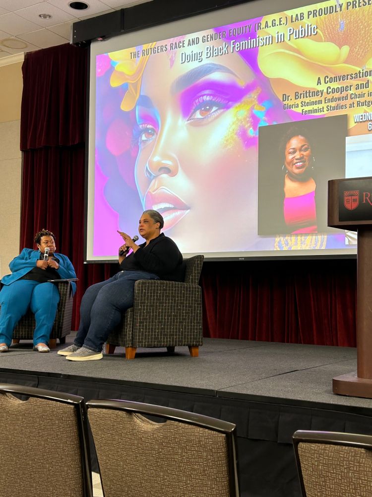 Brittney Cooper and Roxane Gay seated on stage in Trayes Hall at Rutgers University for the launch of RAGE Lab