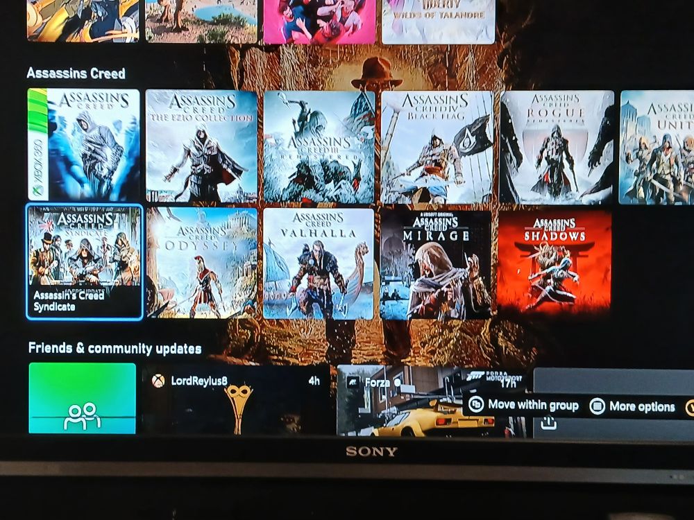 A screenshot of my xbox Home Screen, showing the Assassins creed folder that features the titles: Ac1, Ezio Collection, Ac3 remastered, Black Flag, Rogue remastered. Unity, Syndicate, Odyssey, Valhalla, Mirage and Shadows.

There is also a dynamic wallpaper featuring Indian Jones 