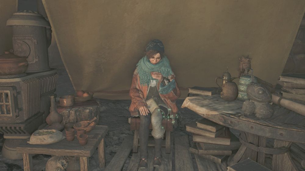 Monster Hunter Wilds screenshot of Alma sitting with a cup of tea in her hand