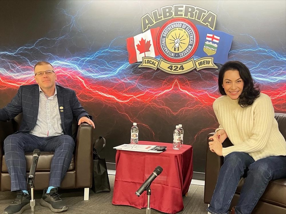 Heather and IBEW leadership sitting on a stage.