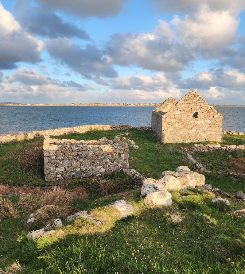 Image of ruins of a stone house with stone walls near the ocean