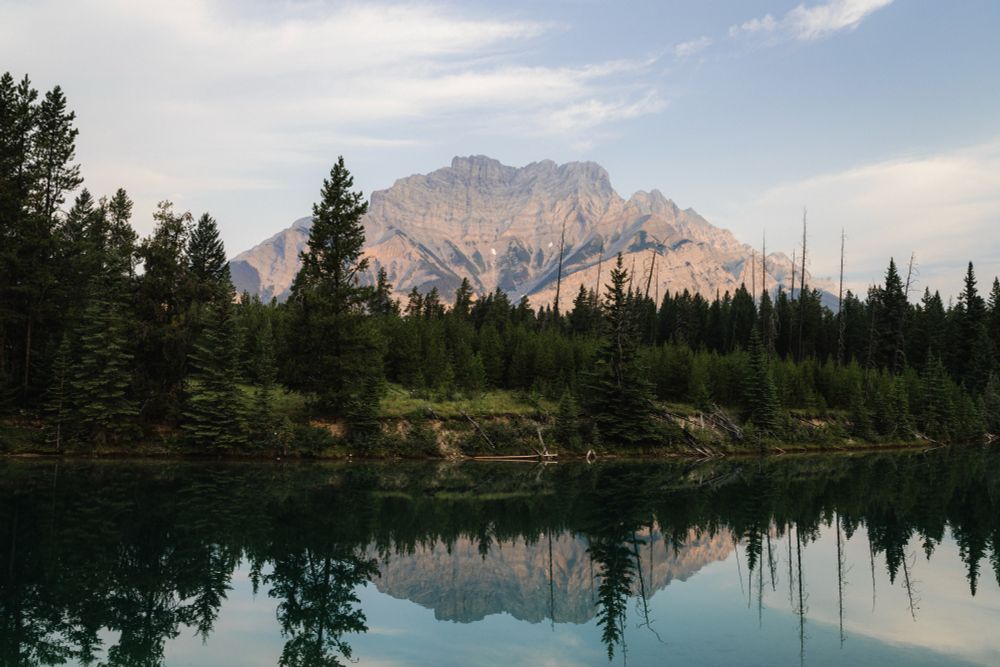 Mountain at sunrise, reflected in a lake.