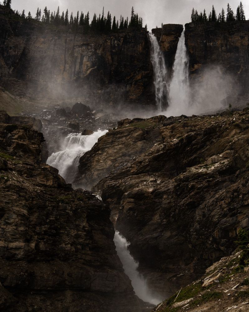 Twin waterfalls cascading over rocky terrain.