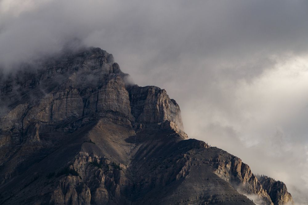 Mountain side shrouded in cloud.
