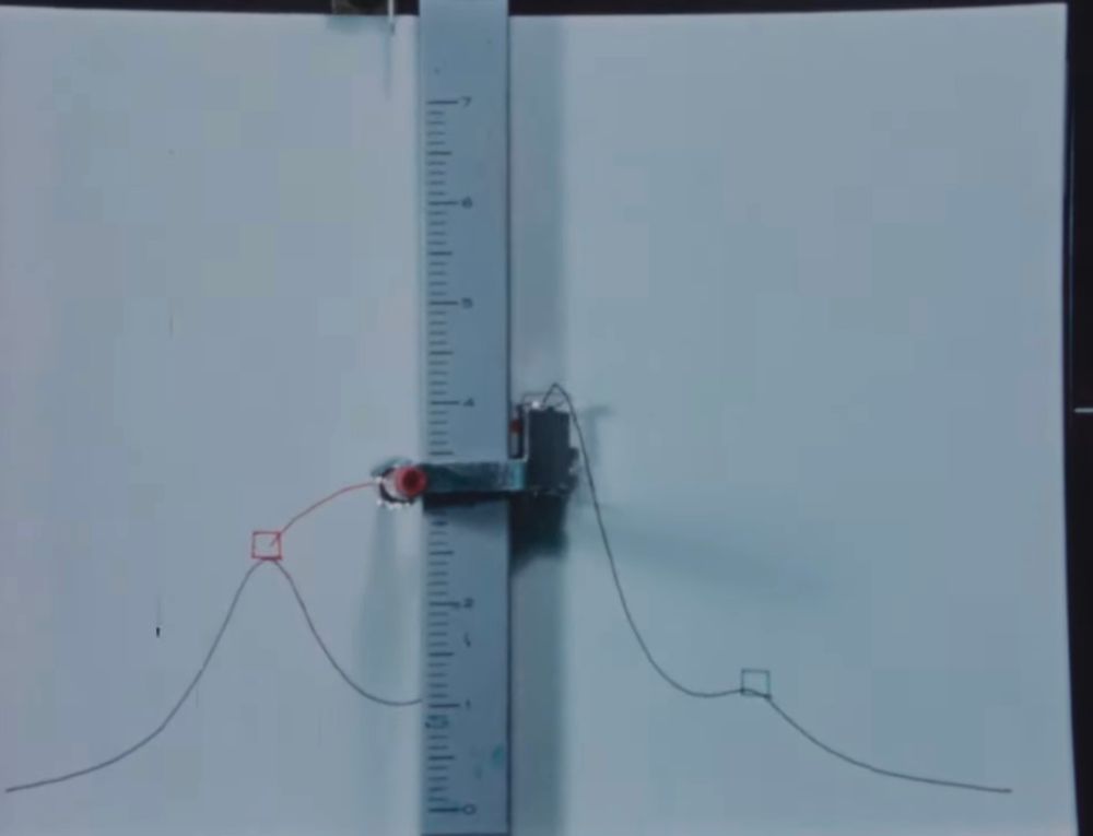 A computerized plotter, drawing the arc of a projectile in an artillery-style game.