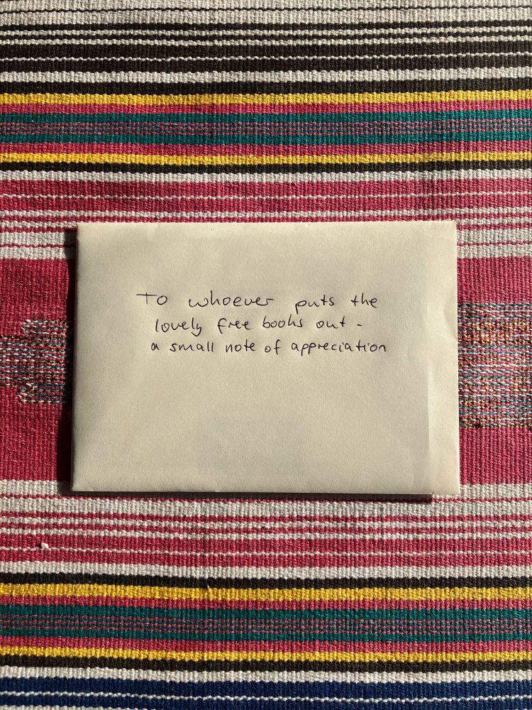 An envelope that says “To whoever puts the lovely free books out - a small note of appreciation.”