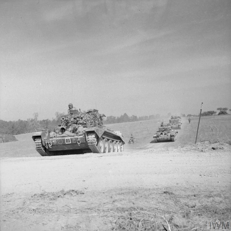 Cromwell tanks drive across dry countryside.