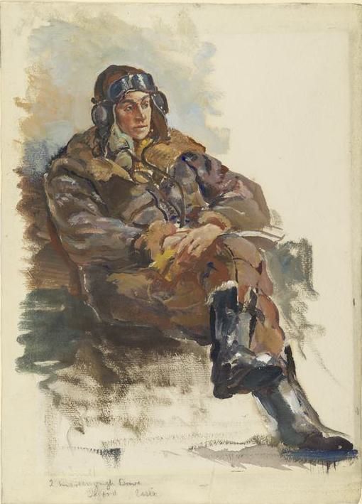 A man in flying gear sits ion a chair.