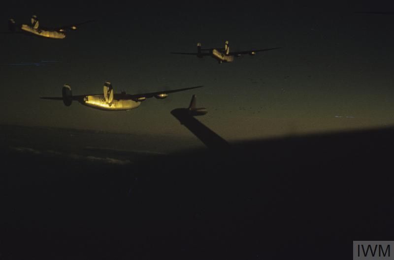 A photograph taken at sunset from an aircraft showing three other aircraft lit by the sun from a low angle.