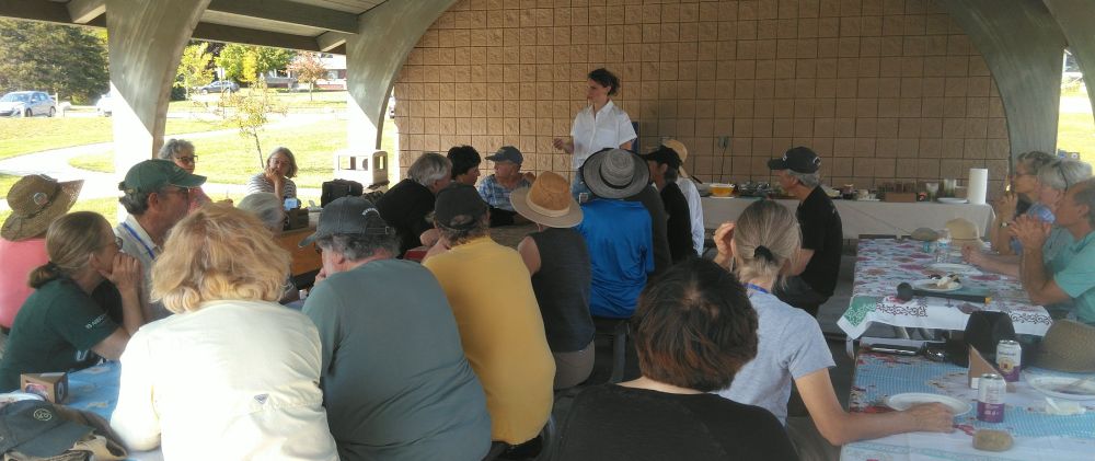 Callie Barr who is the candidate running for Michigan First District in the 2026 election addressing citizens who are members of Leelanau Indivisible at our Suttons Bay Michigan picnic celebrating the volunteers who gathered weekly across Leelanau County Michigan to protest the tyranny of the current administration peacefully and respectfully yet focused on our grievances as citizens of the United States of America under the First Amendment.