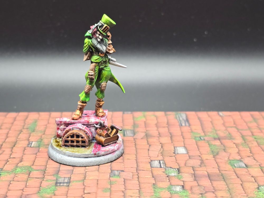 The front of my Seamus model, painted in bright greens to make him look like a leprechaun and standing on a 3d printed sewer base.