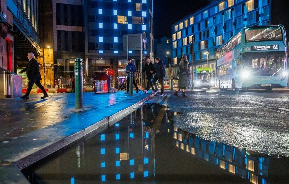 A photograph taken at night of Hope Street in Glasgow city centre at the junction of Oswald Street and Argyle Street.
