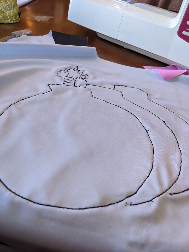 Spandex applique in progress: the backside of a big stitched cartoon bomb.