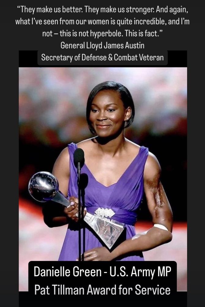 Black woman with a prosthetic limb on her left arm holding an award for military service. 