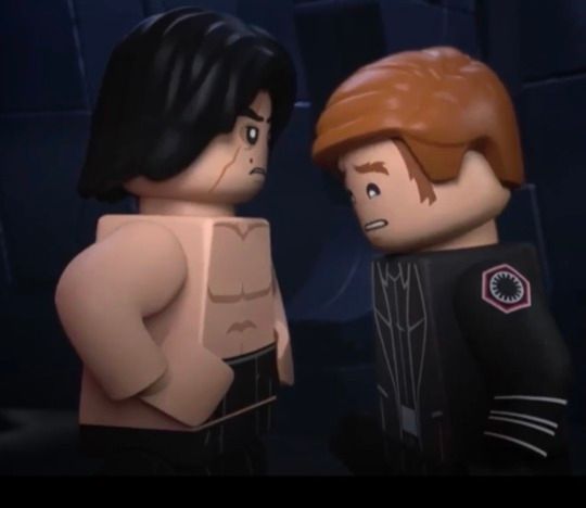 Lego Kylo Ren, shirtless, stands in front of Lego General Hux. Hux is staring down at Kylo's chest.