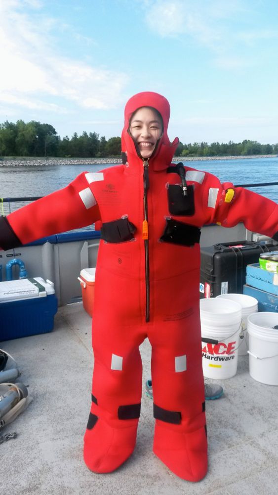 Edna wearing a giant red "lobster" suit on a ship on Muskegon Lake as safety training for a sampling cruise on Lake Michigan.