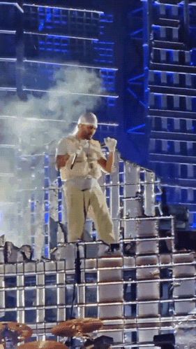 a man is standing on a stage holding a microphone