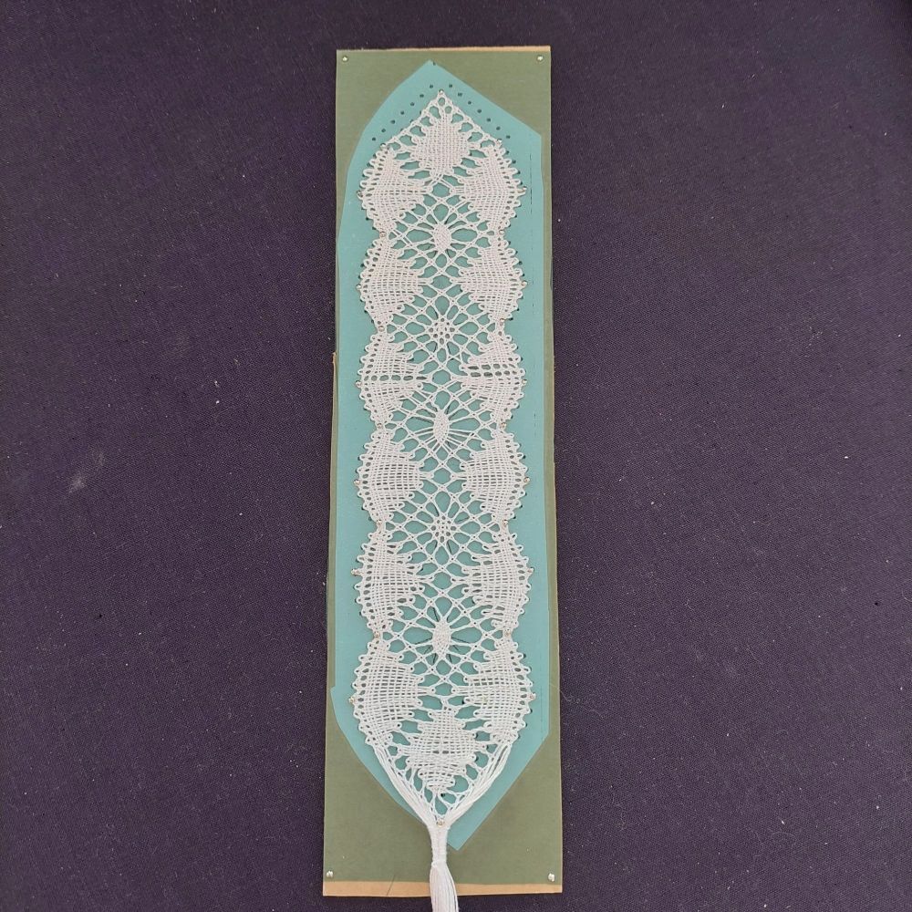 Torchon lace sampler of fans and spiders with experiments in adding twist