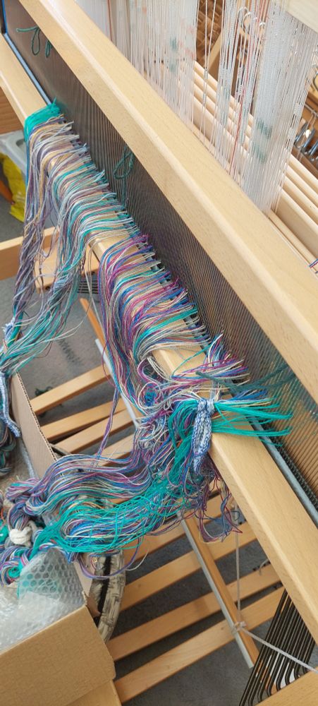 A floor loom with its reed threaded ready for warping front to back