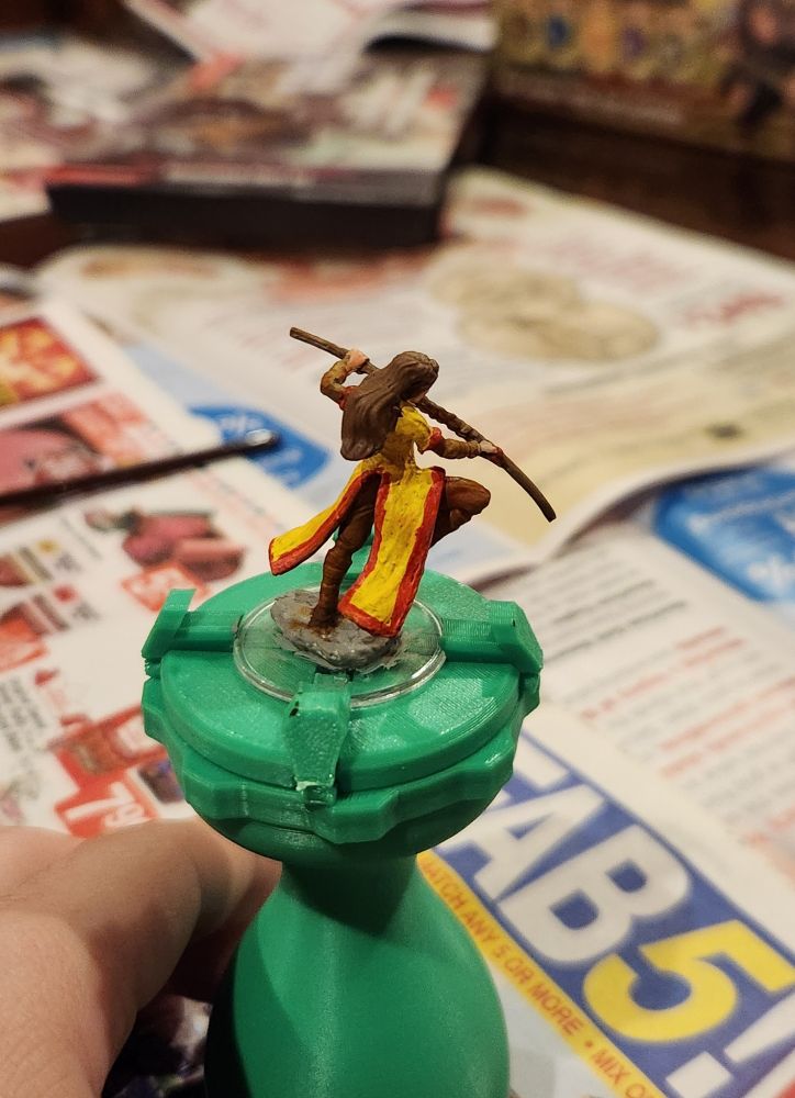Painted mini monk yellow and red robes with a staff