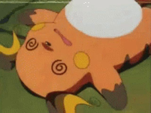 a cartoon character is laying on the ground with a white circle on its face .